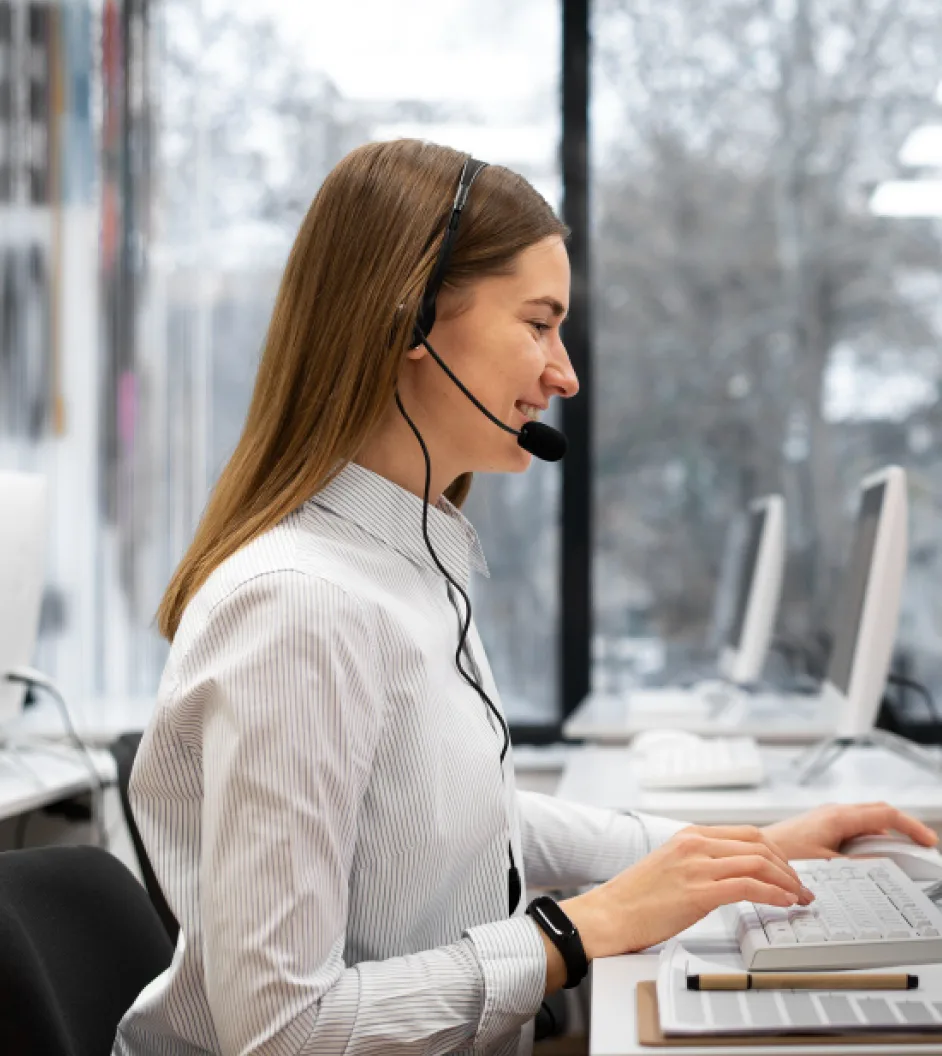 a woman wearing a headset working on a computer